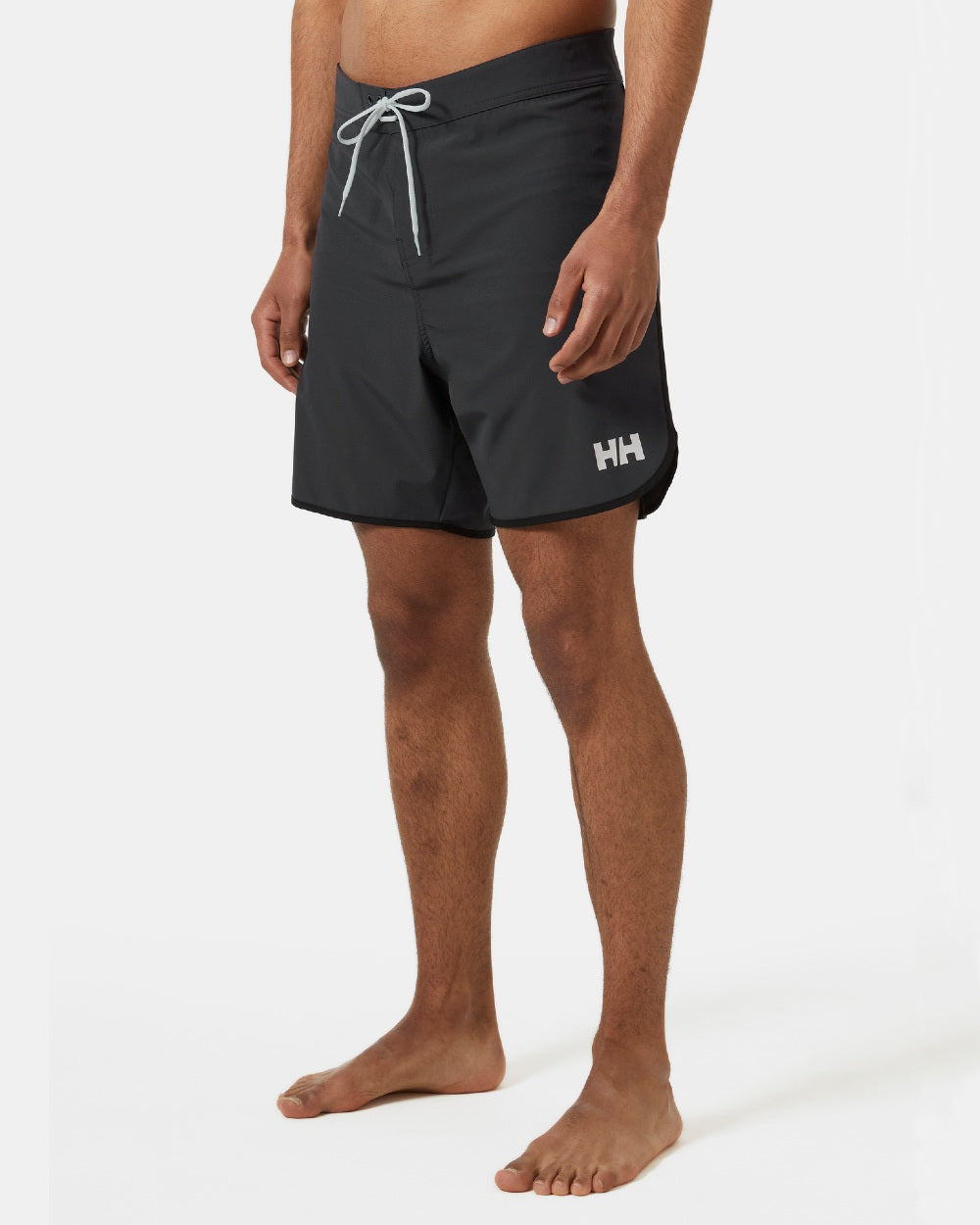 Ebony coloured Helly Hansen Mens HP 7 inch Curve Board Shorts on grey background 