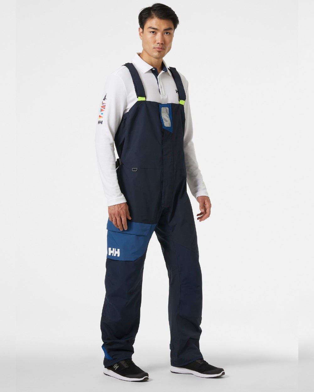 Navy coloured Helly Hansen Mens Newport Coastal Sailing Bib on grey background 