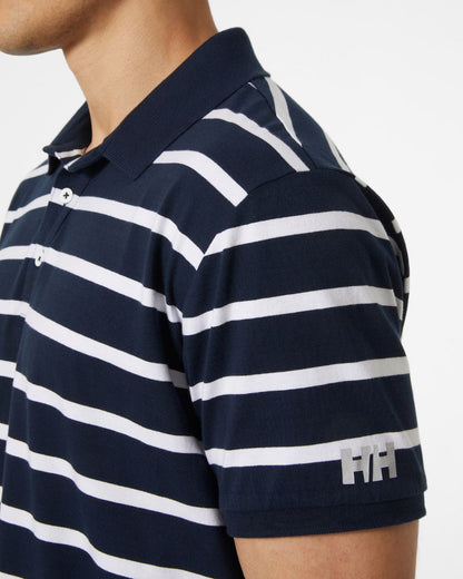 Navy coloured Helly Hansen Mens Newport Polo Shirts on grey background 