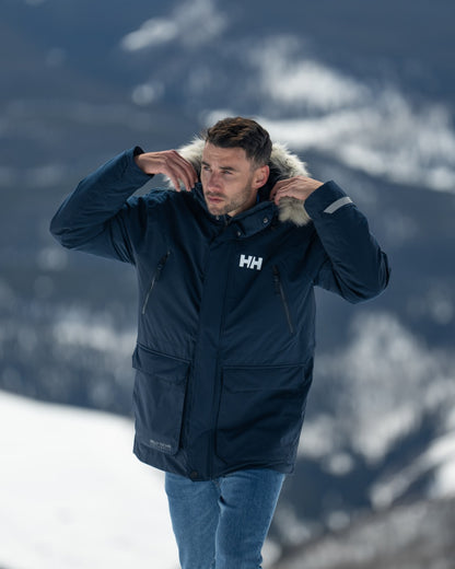 Navy Coloured Helly Hansen Mens Reine Winter Parka on Outdoor Background
