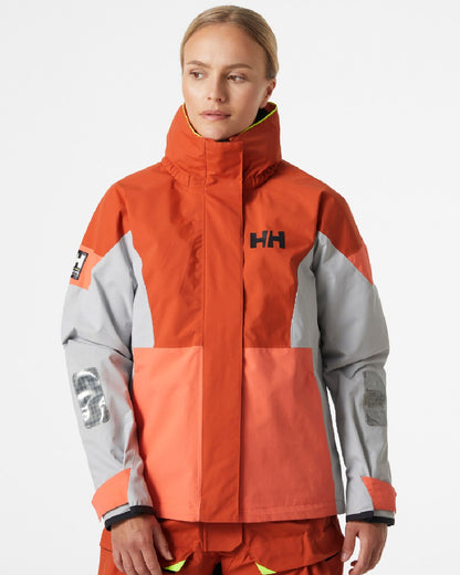 Terracotta coloured Helly Hansen Womens Newport Coastal Jacket on grey background 