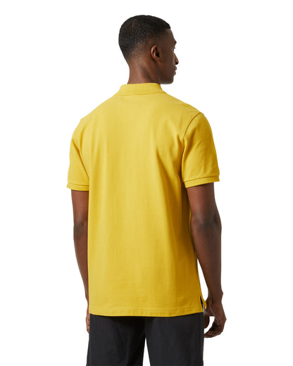 Gold Rush coloured Helly Hansen Polo Shirt on White background 