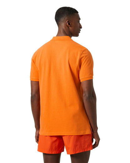 Poppy Orange coloured Helly Hansen Polo Shirt on White background 