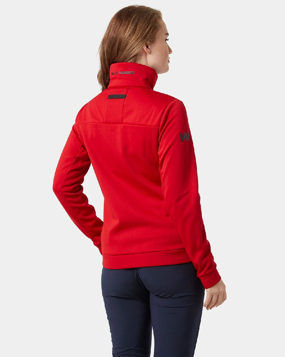 Red coloured Helly Hansen Womens Crew Fleece Jacket on grey background 