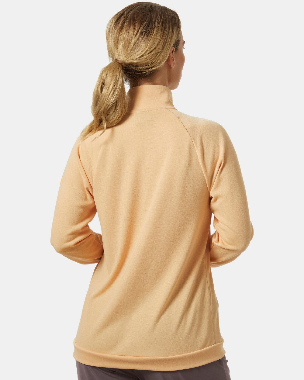 Miami Peach coloured Helly Hansen Womens Inshore Half Zip Pullover on grey background 