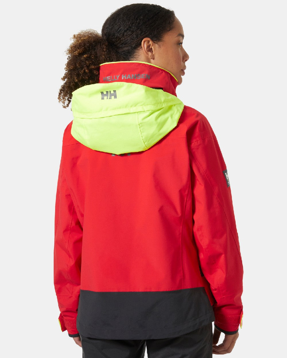 Alert Red coloured Helly Hansen Womens Pier 3.0 Coastal Sailing Jacket on grey background 