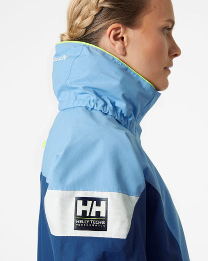 Bright Blue coloured Helly Hansen Womens Newport Regatta Sailing Jacket on grey background 