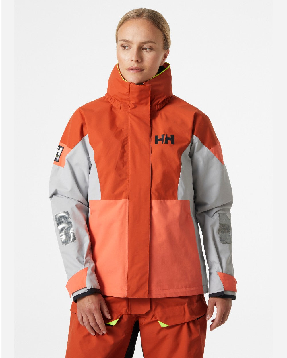 Terracotta coloured Helly Hansen Womens Newport Regatta Sailing Jacket on grey background 