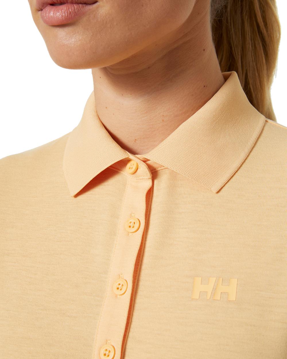 Miami Peach coloured Helly Hansen Womens Siren Quick Dry Polo T-shirt on white background 