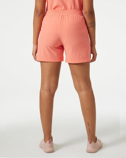 Peach Echo coloured Helly Hansen womens thalia shorts 2.0 on grey background 