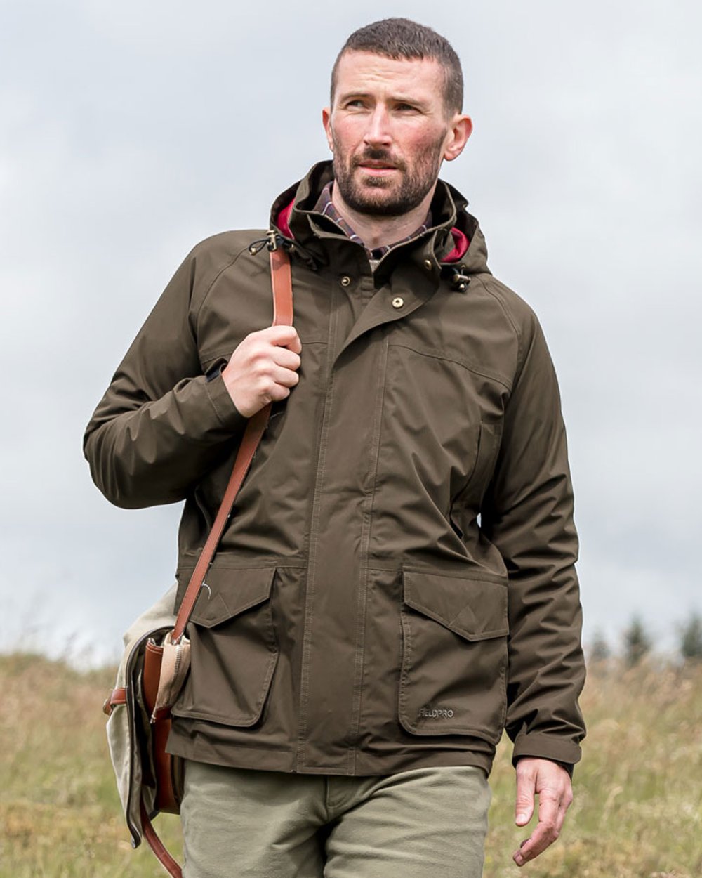 Fern Green Coloured Hoggs of Fife Culloden Waterproof Field Jacket on sky background 