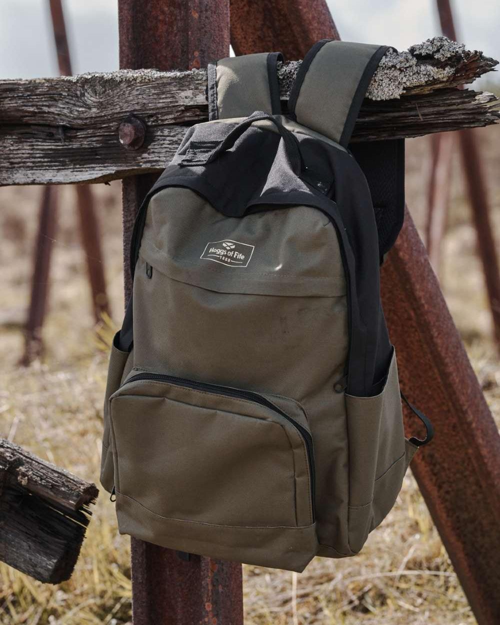 Green Black Coloured Hoggs of Fife Field &amp; Trek Backpack on wood background 