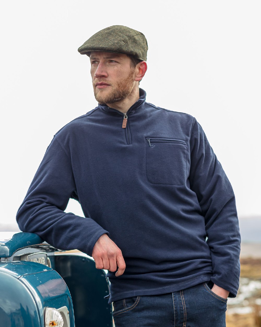 Navy coloured Hoggs of Fife Islander 1/4 Zip Micro Fleece Shirt with model on grey background 