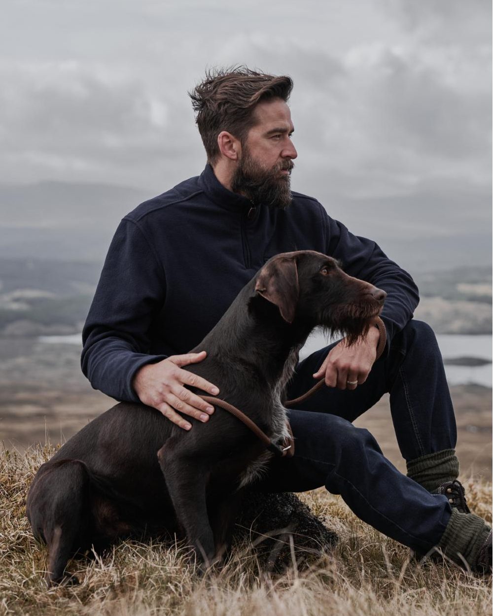 Navy coloured Hoggs of Fife Islander 1/4 Zip Micro Fleece Shirt on model with mountain background 