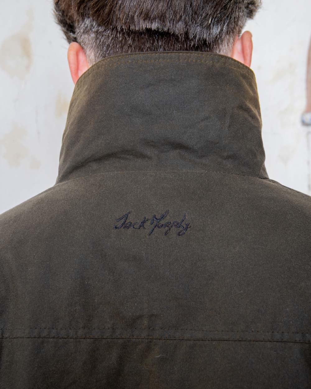 Olive coloured Jack Murphy Archie Wax Jacket Collar on White wall background 