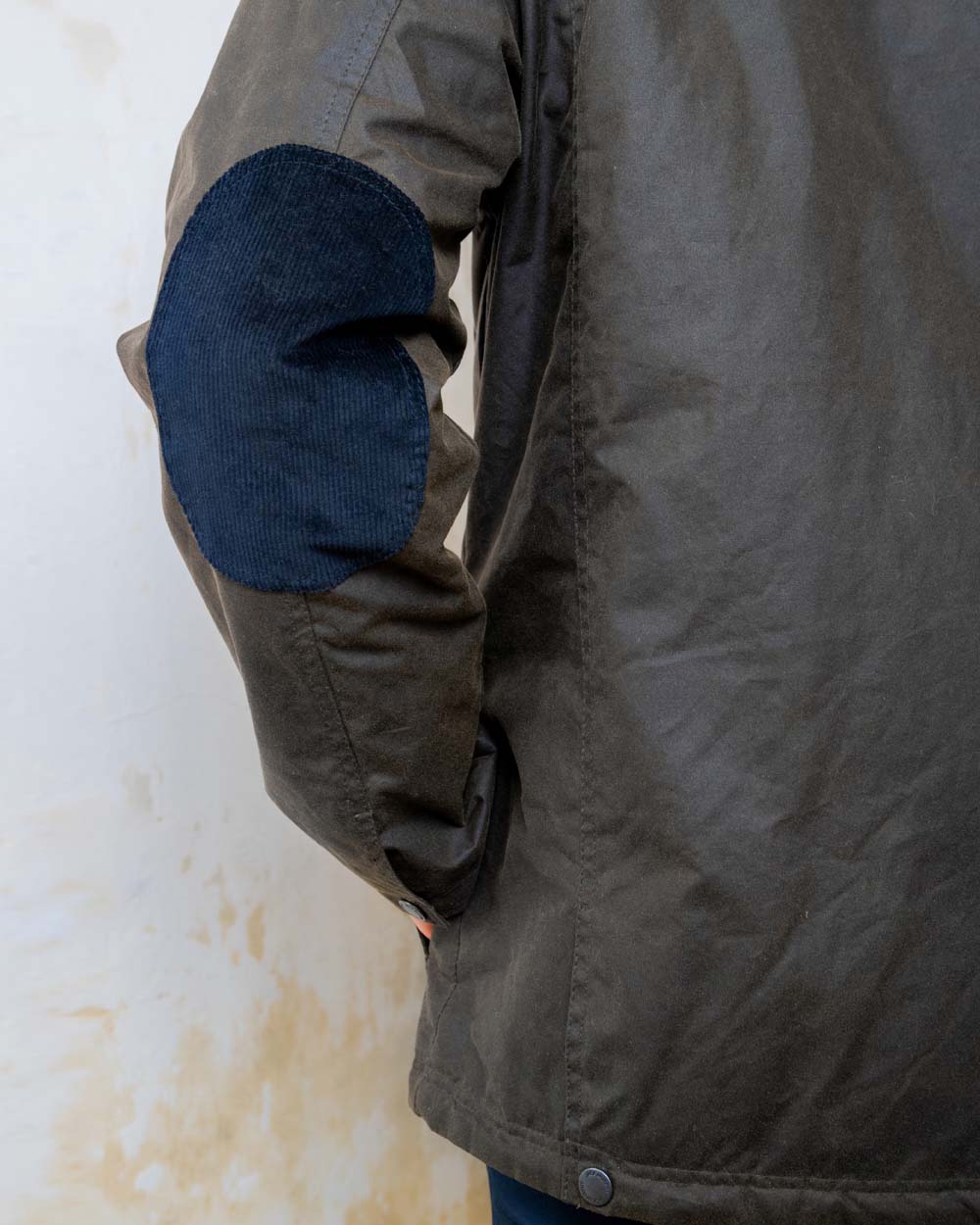 Olive coloured Jack Murphy Archie Wax Jacket Elbow Patch on White wall background 