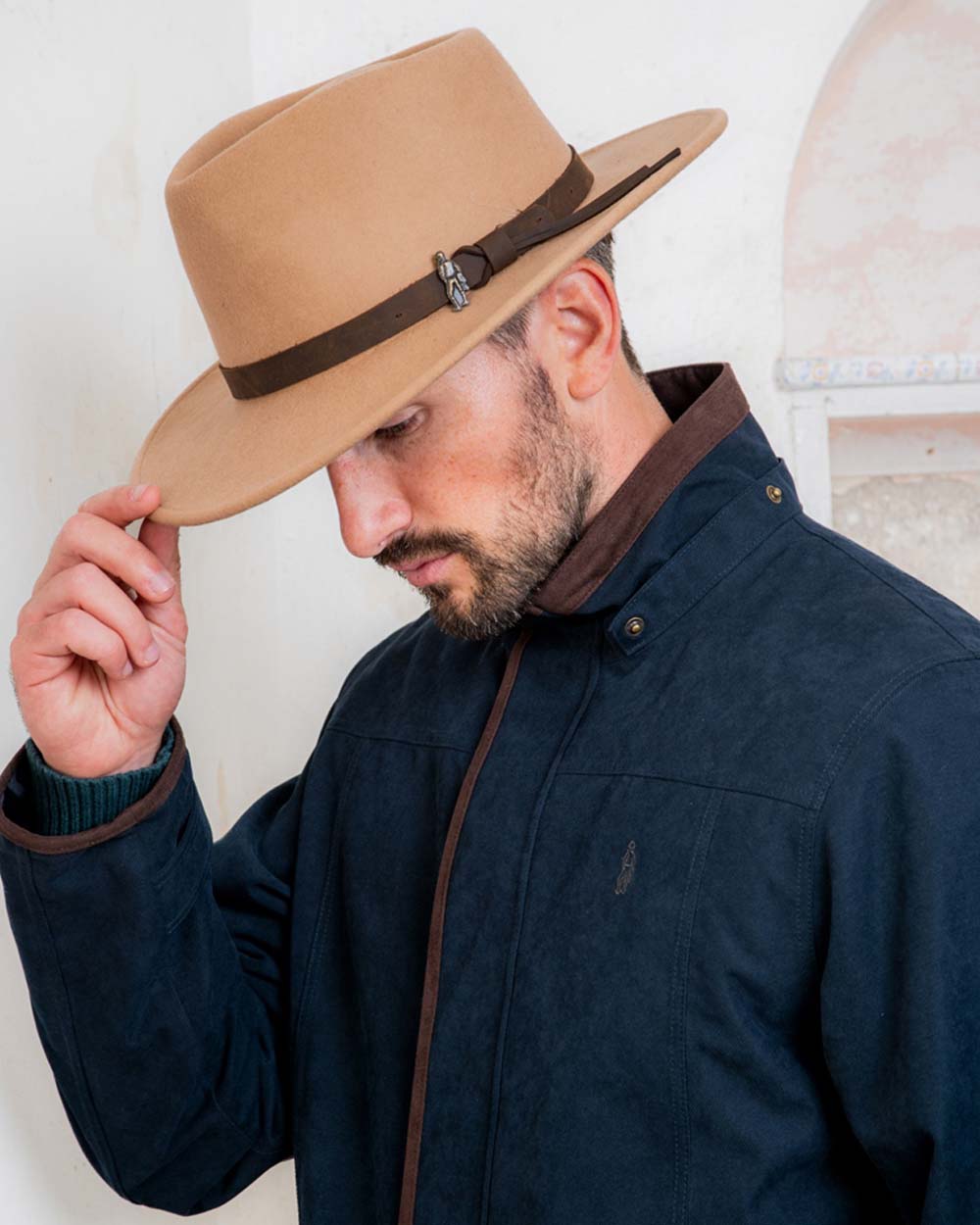 Tan coloured Jack Murphy Boston Crushable Felt Hat on wall background 