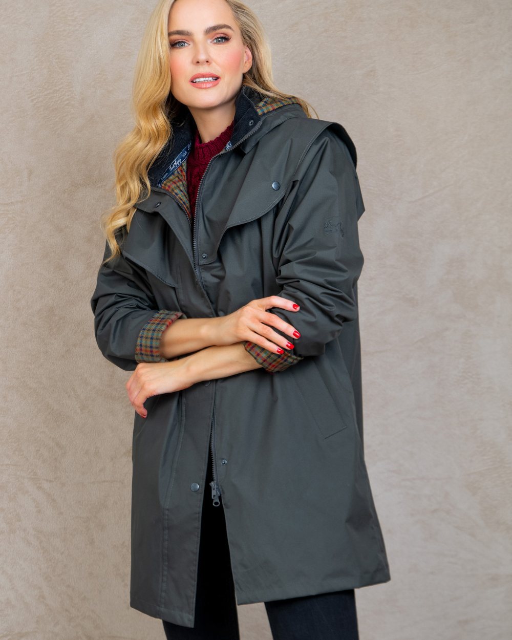 Olive coloured Jack Murphy Cotswold Ladies Waterproof 3/4 Coat on wall background 