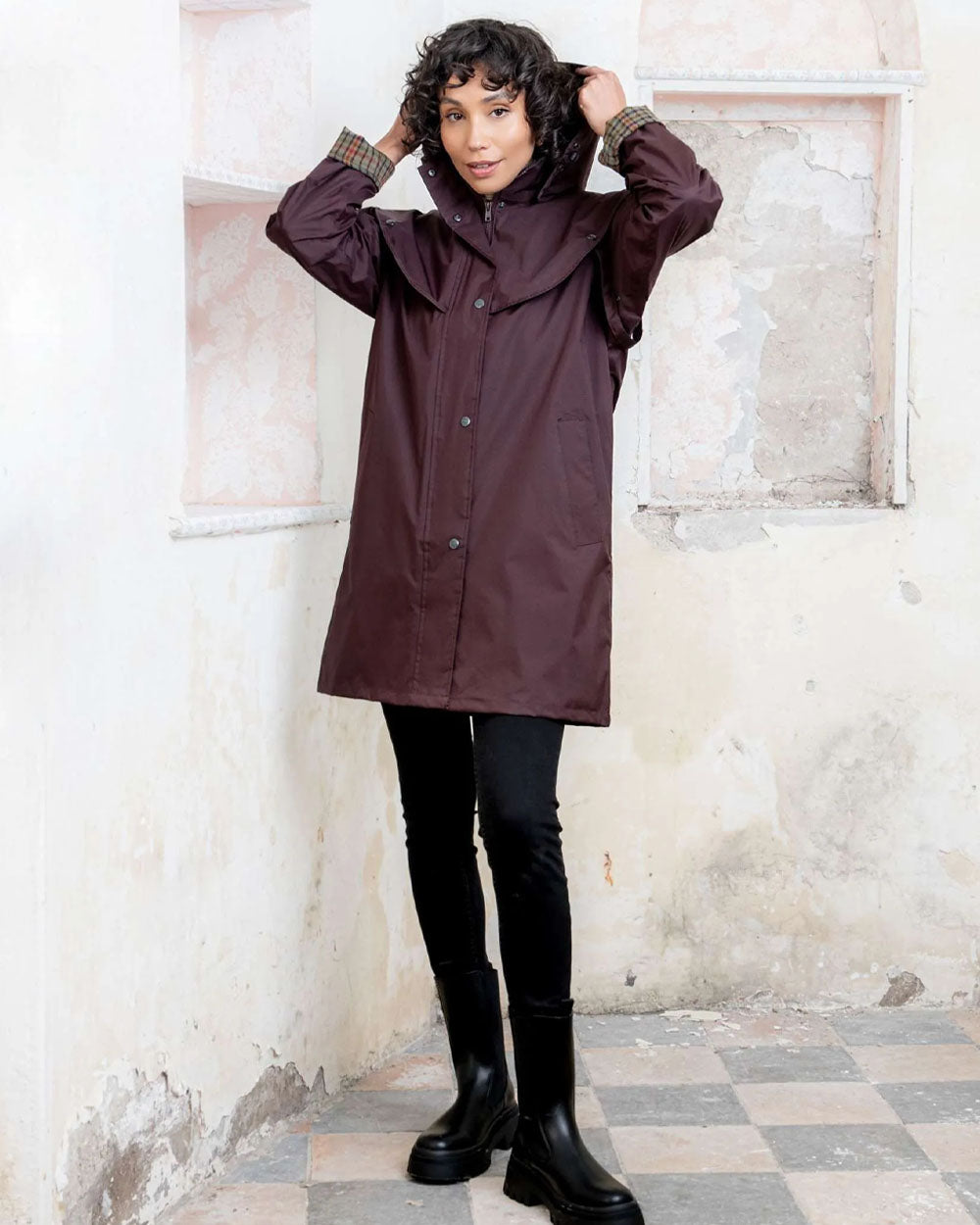 Deep Claret coloured Jack Murphy Cotswold Ladies Waterproof 3/4 Coat on wall background 