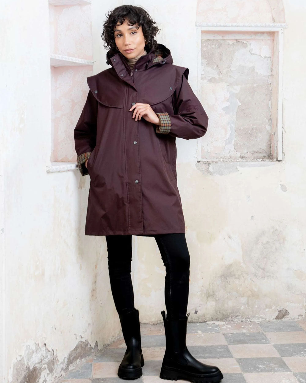 Deep Claret coloured Jack Murphy Cotswold Ladies Waterproof 3/4 Coat on wall background 