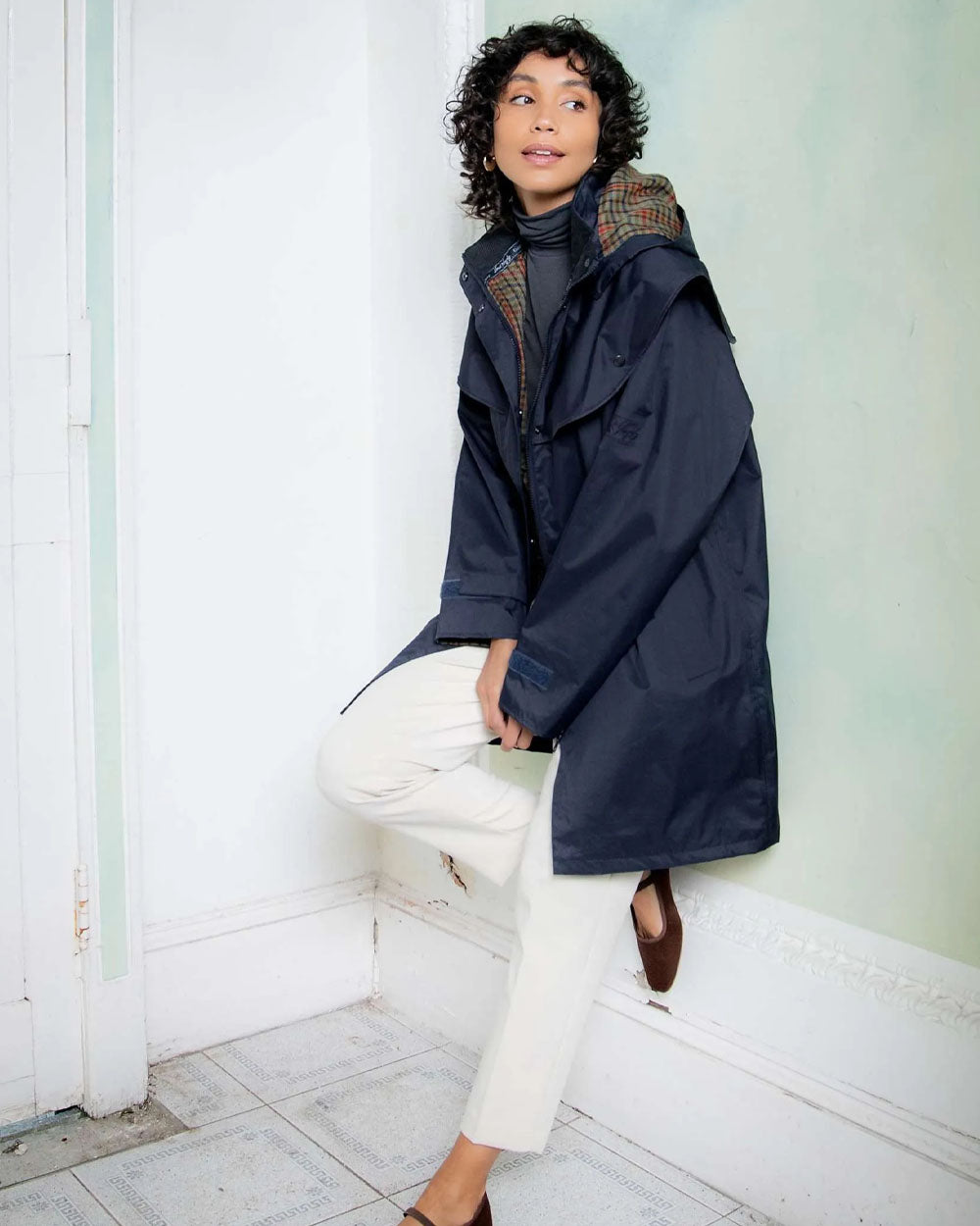 Heritage Navy coloured Jack Murphy Cotswold Ladies Waterproof 3/4 Coat on wall background 