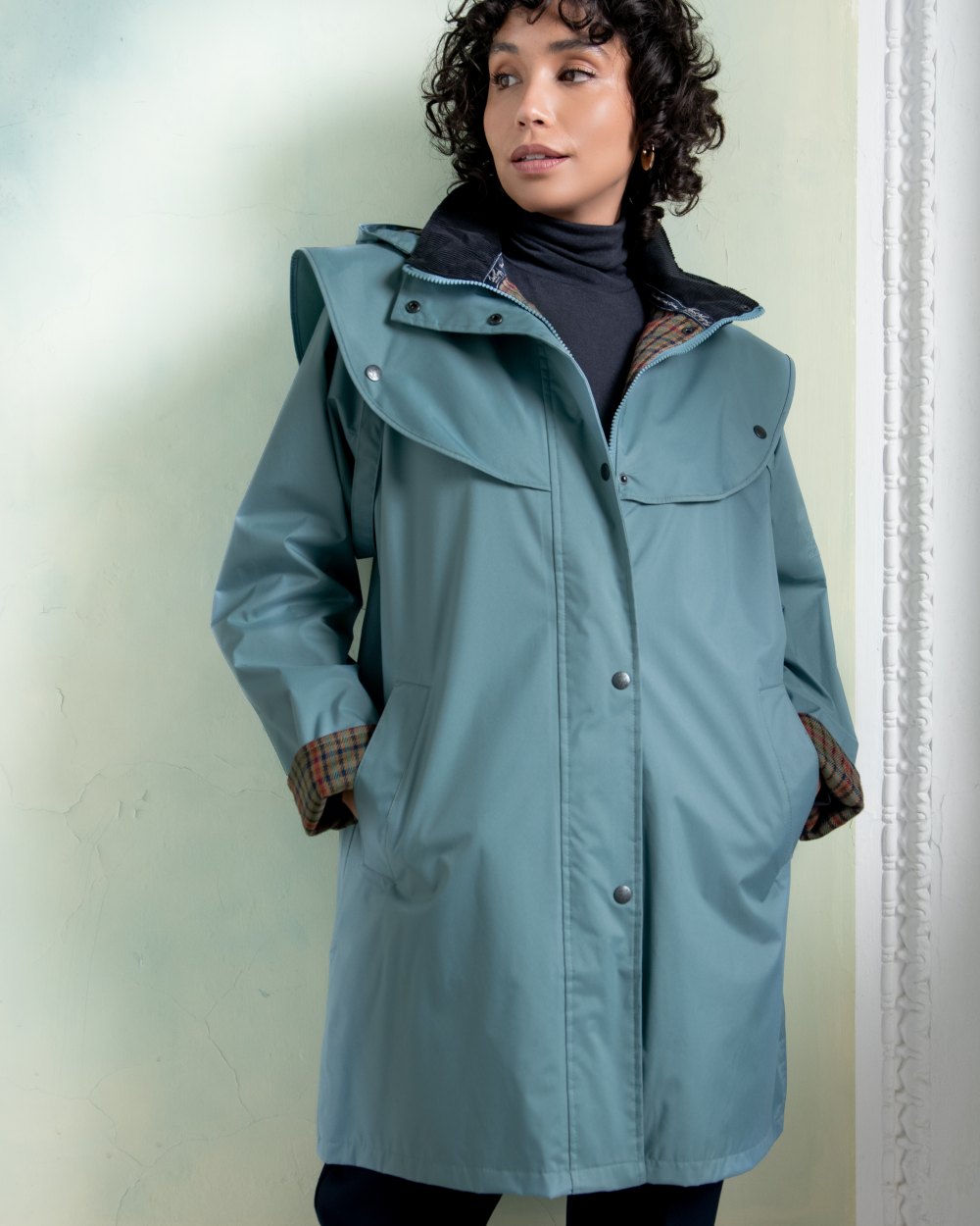 Smoke Blue coloured Jack Murphy Cotswold Ladies Waterproof 3/4 Coat on Teal background 