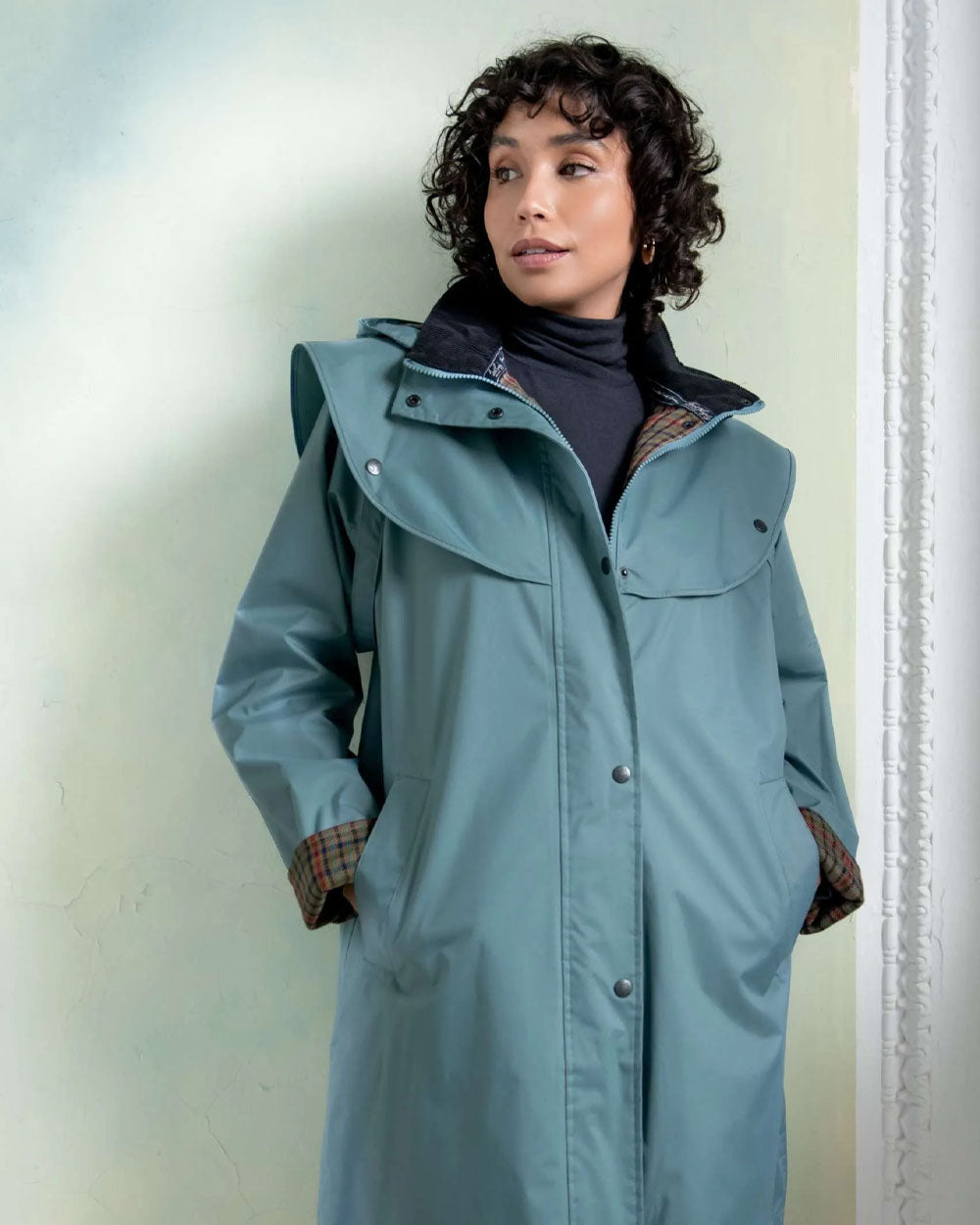 Smoke Blue coloured Jack Murphy Cotswold Ladies Waterproof 3/4 Coat on Teal background 