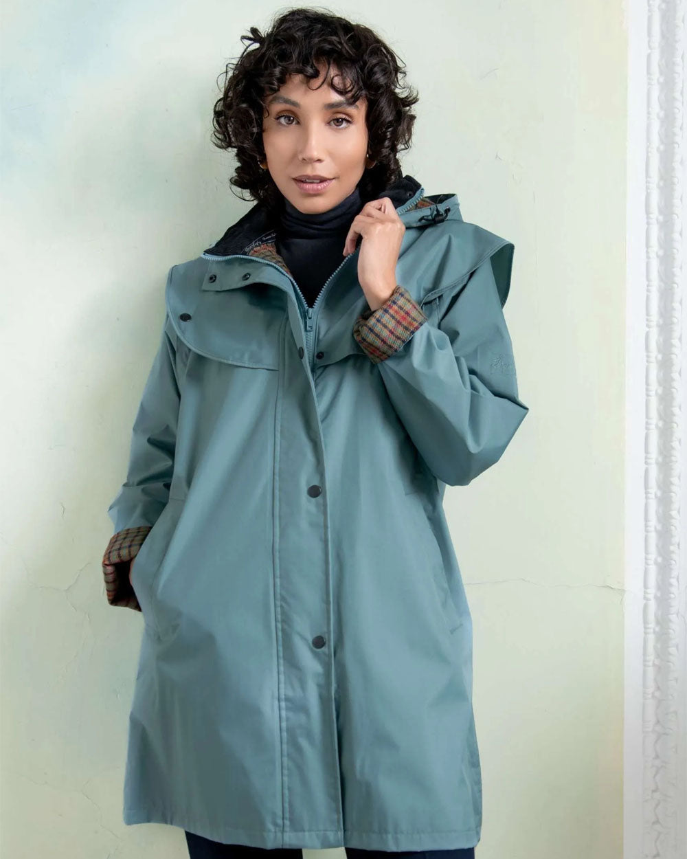 Smoke Blue coloured Jack Murphy Cotswold Ladies Waterproof 3/4 Coat on Teal background 