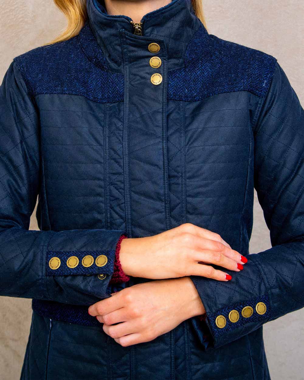 Navy coloured Jack Murphy Jodie Wax Coat on Pastel background 