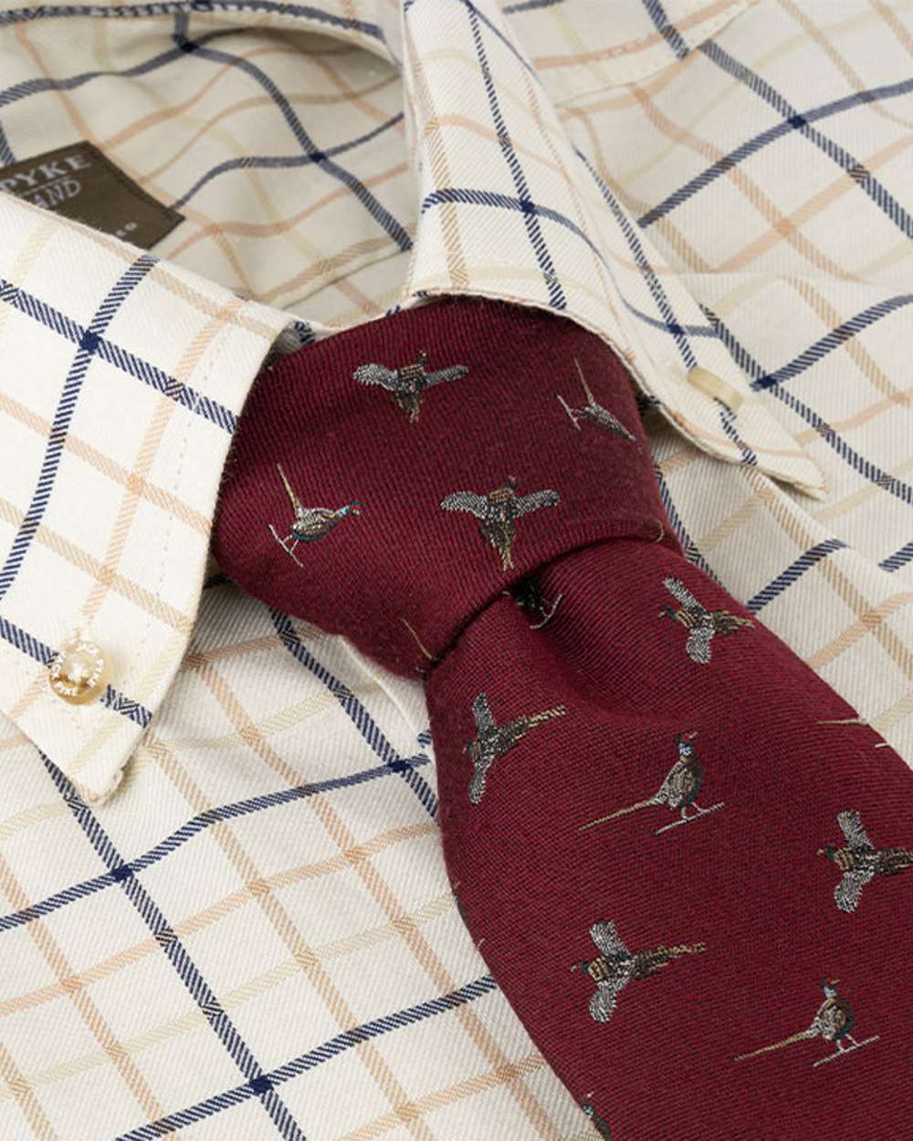 Burgundy coloured Jack Pyke Silk Tie Pheasant on shirt background 