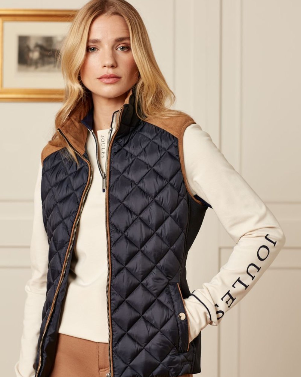 Navy Coloured Joules Braemar Luxe Gilet On A House Background 