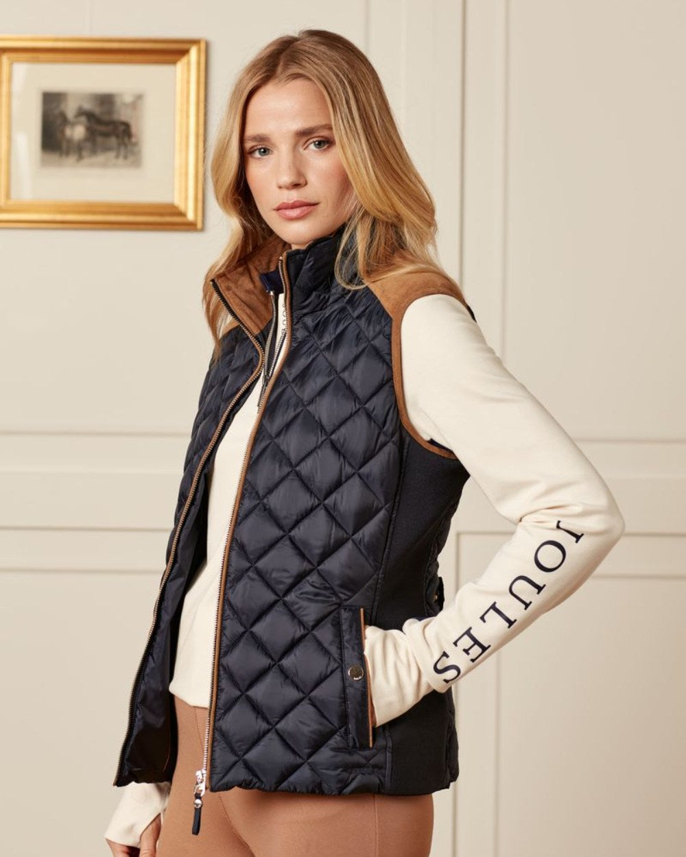 Navy Coloured Joules Braemar Luxe Gilet On A House Background 