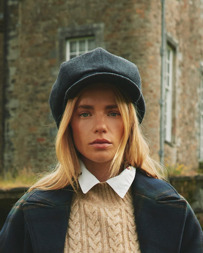 Navy Coloured Joules Elvaston Baker Boy Hat On A Outer Yard Background 