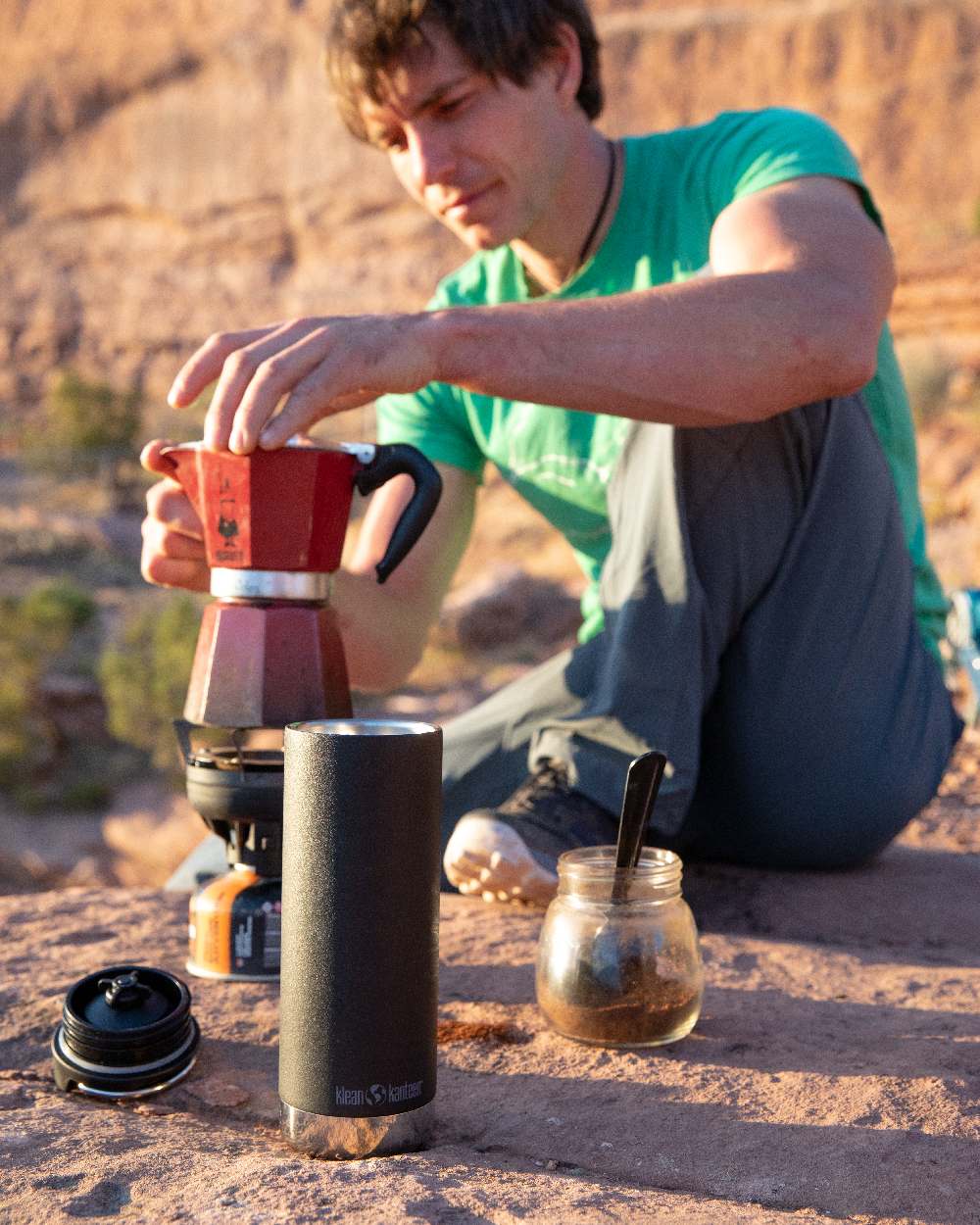 Black Coloured Klean Kanteen Insulated TKWide With Cafe Cap On A Sand Background 