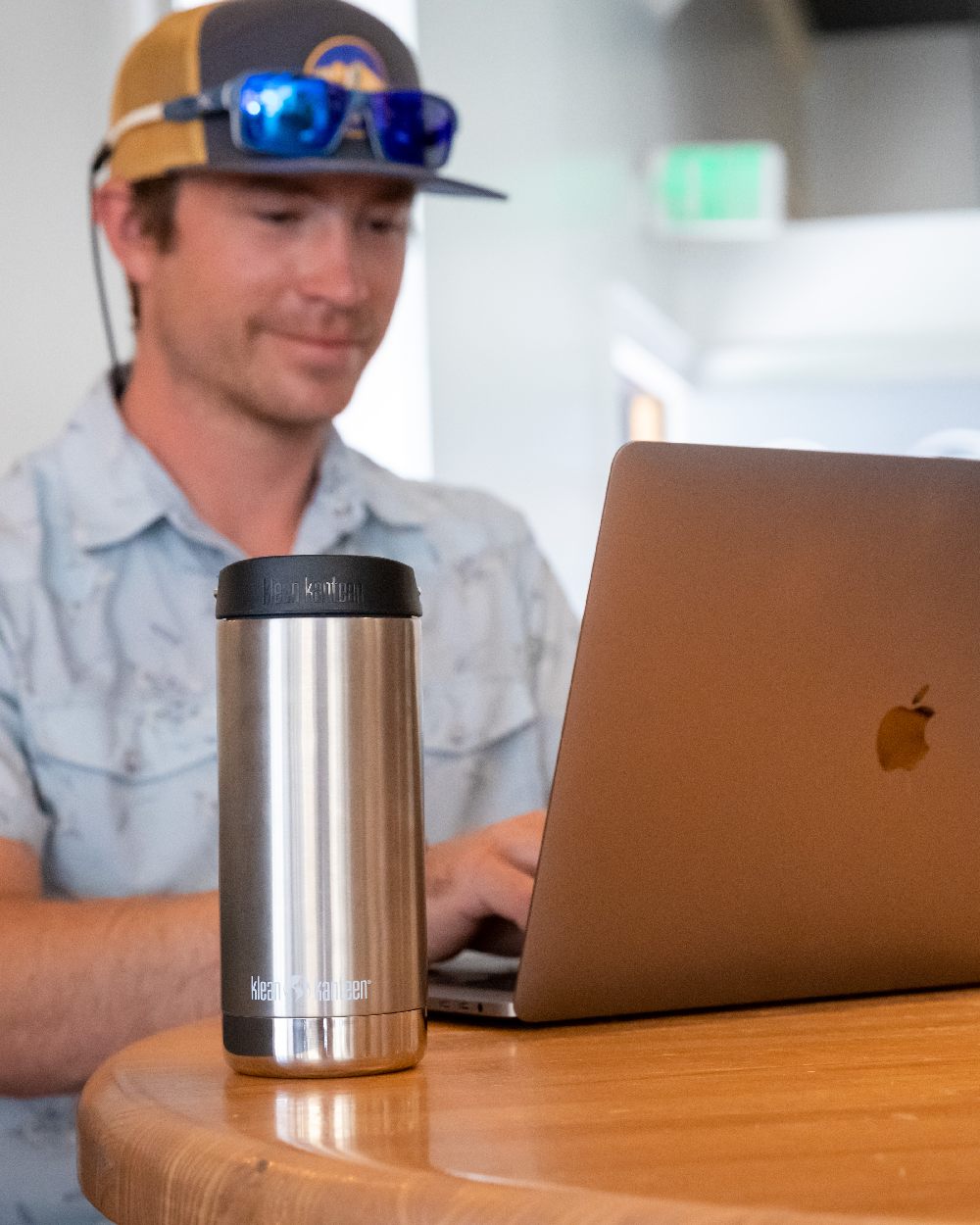 Brushed Stainless Coloured Klean Kanteen Insulated TKWide With Cafe Cap On A Desk Background 