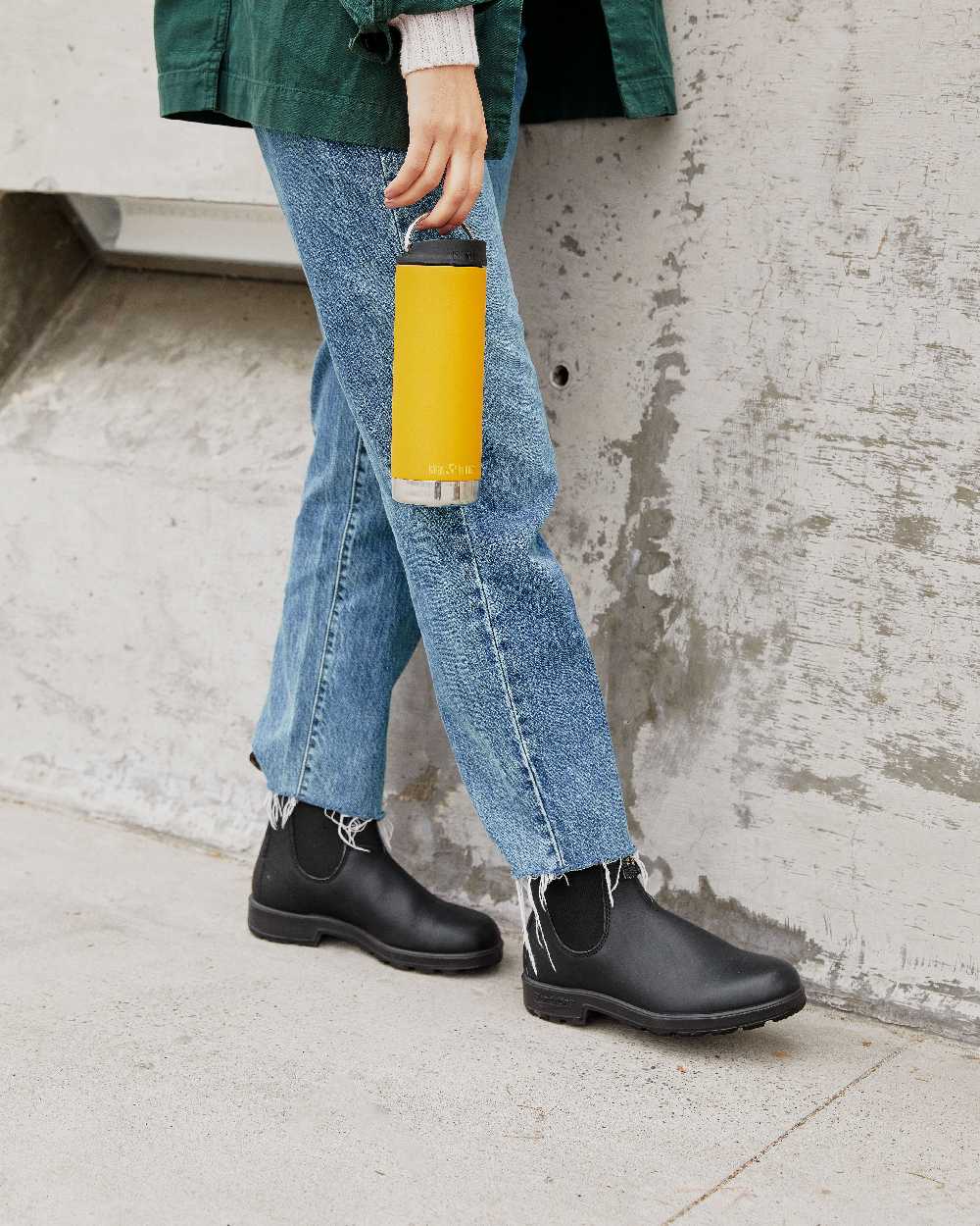 Marigold Coloured Klean Kanteen Insulated TKWide With Cafe Cap On A Floor Background 