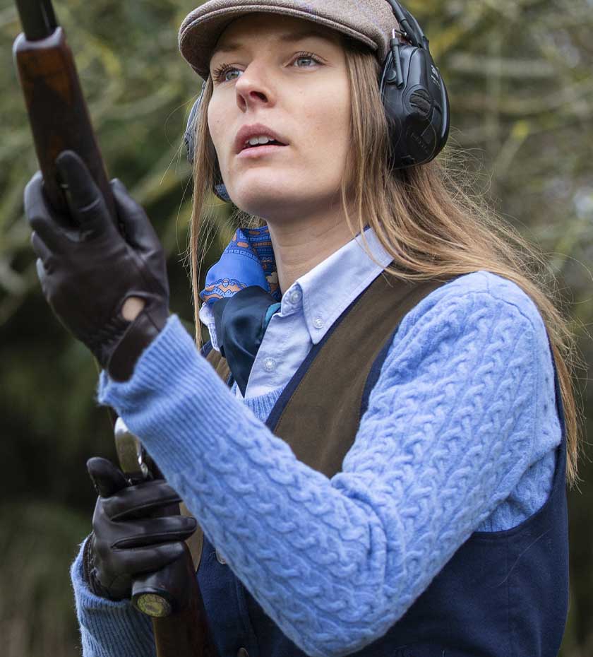 Laksen Jumpers | Lady wears blue cable knit sweater whilst shooting.