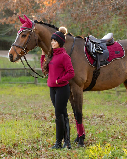 Ember Coloured LeMieux Adele Funnel Neck Sweatshirt On A Outer Yard Background 