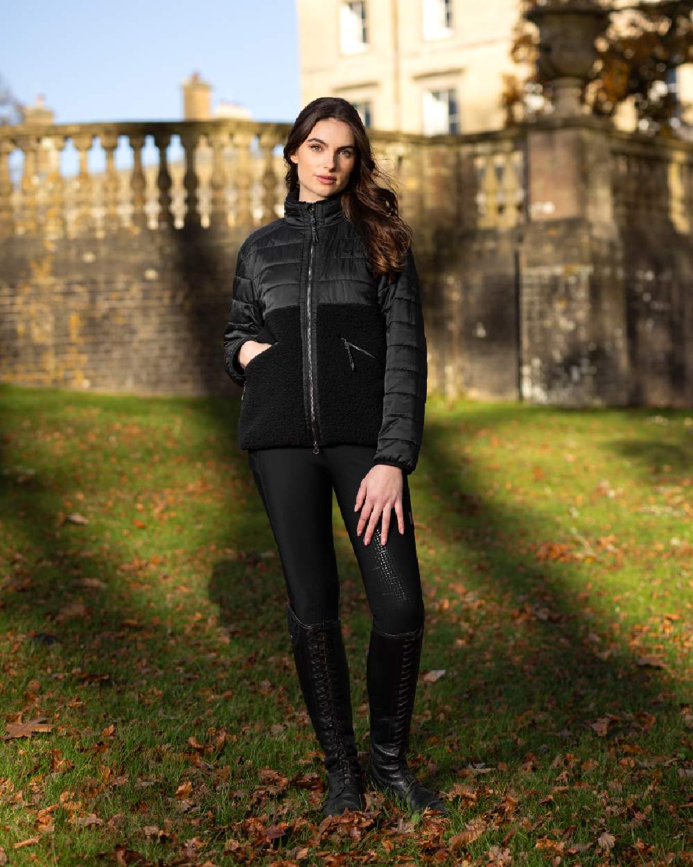 Black Coloured LeMieux Alissa Hybrid Fleece Jacket On A Front Yard Background 