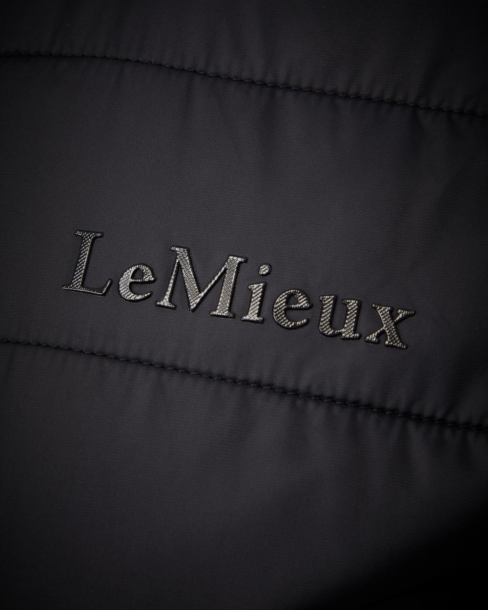 Black Coloured LeMieux Alissa Hybrid Fleece Jacket On A White Background 