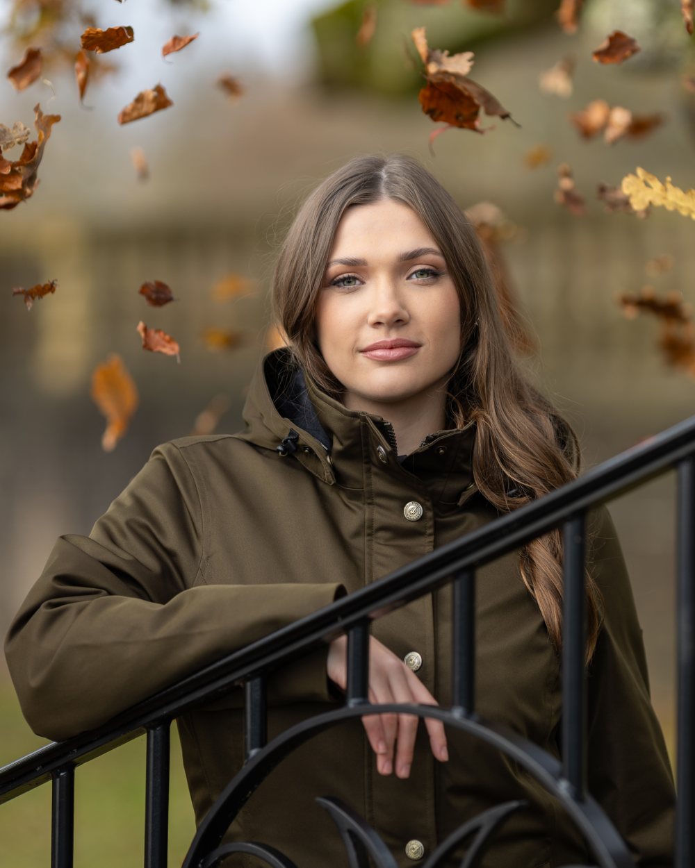 Alpine Coloured LeMieux Anya Waterproof Riding Coat On A Front Yard Background 