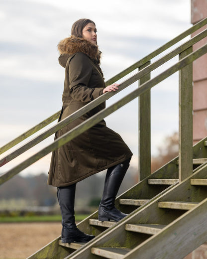 Alpine Coloured LeMieux Anya Waterproof Riding Coat On A Front Yard Background 