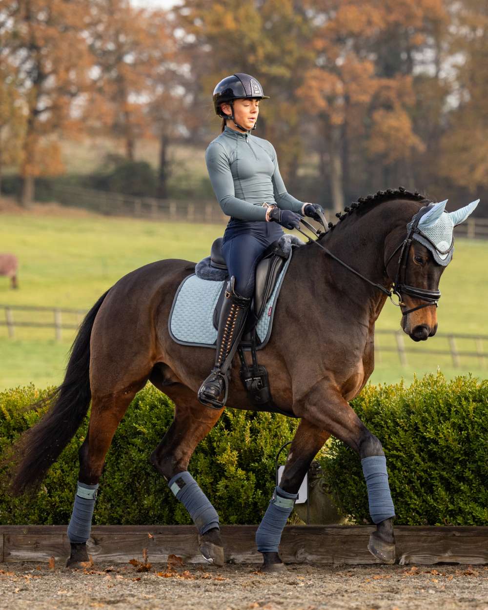 Glacier Coloured LeMieux Base Layer On A Riding Arena Background 