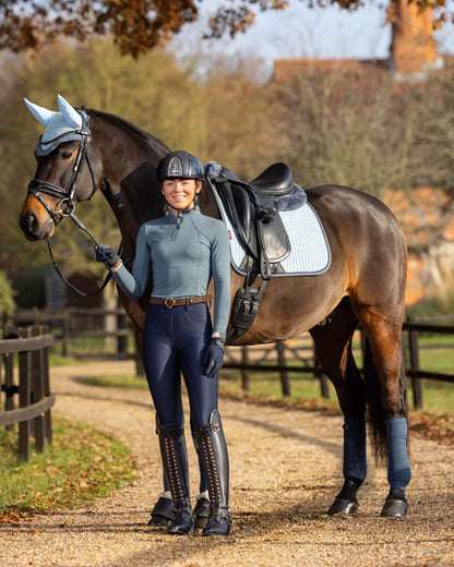 Glacier Coloured LeMieux Base Layer On A Riding Arena Background 