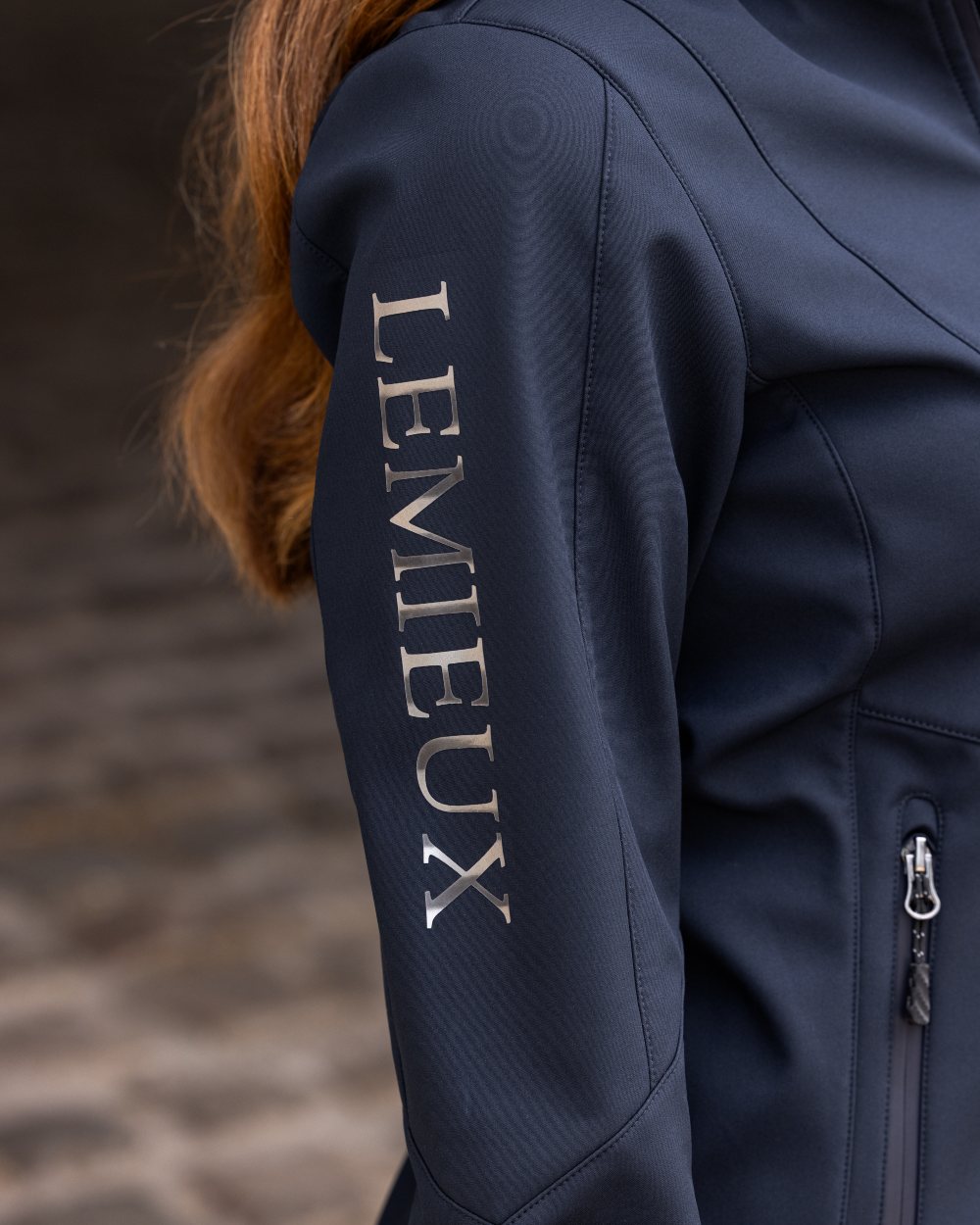 Navy coloured LeMieux Celine Softshell Jacket on grey background 