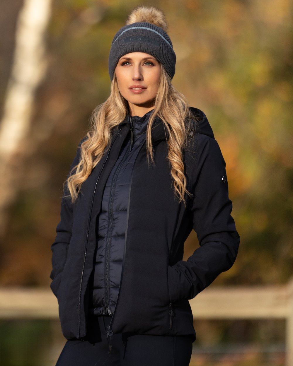 Petrol Coloured LeMieux Clara Cable Beanie On A Outer Yard Background 