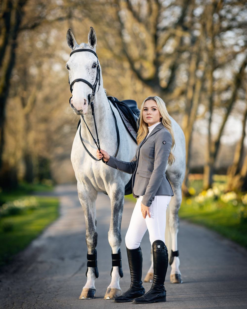 Graphite coloured LeMieux Dynamique Show Jacket with horse in background 