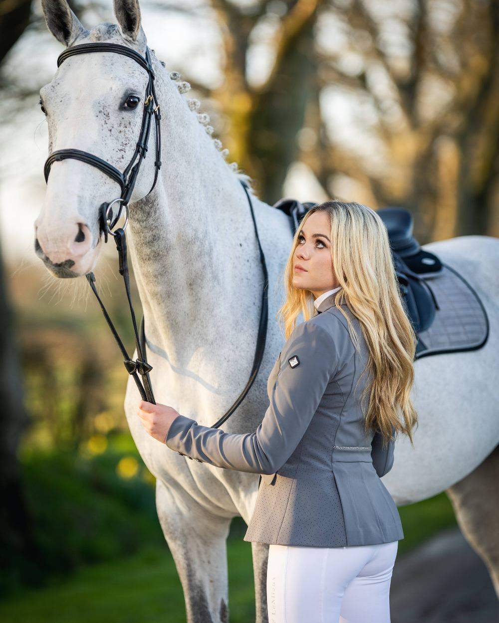 Graphite coloured LeMieux Dynamique Show Jacket with horse in background 