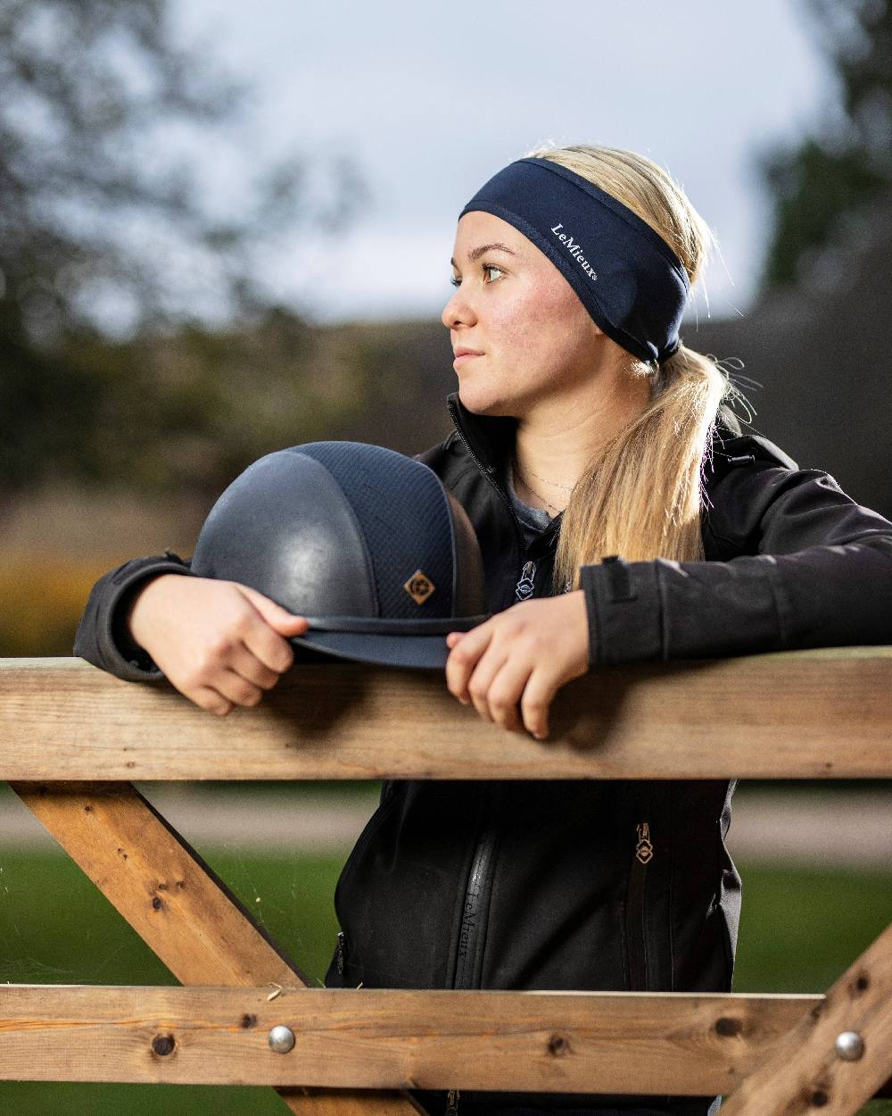 Indigo coloured LeMieux Ear Warmer Headband on Outer Yard background 