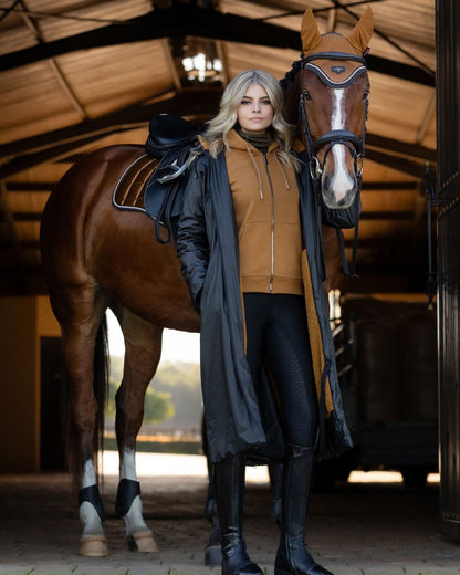 Navy Coloured LeMieux Elements Coat On A Stable Background 